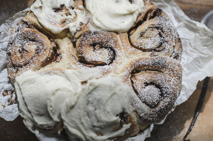 frosted and topped with powdered sugar sourdough apple cinnamon rolls
