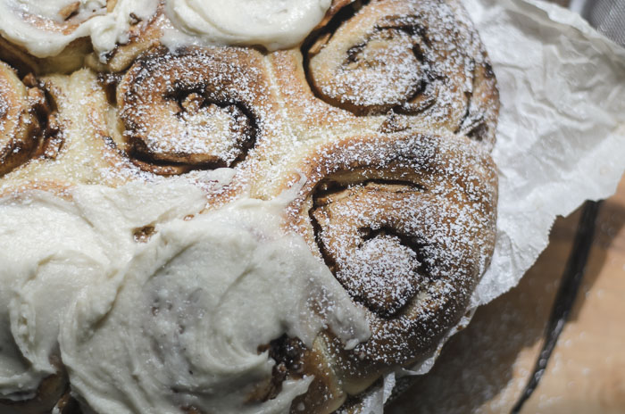 frosted and topped with powdered sugar sourdough apple cinnamon rolls