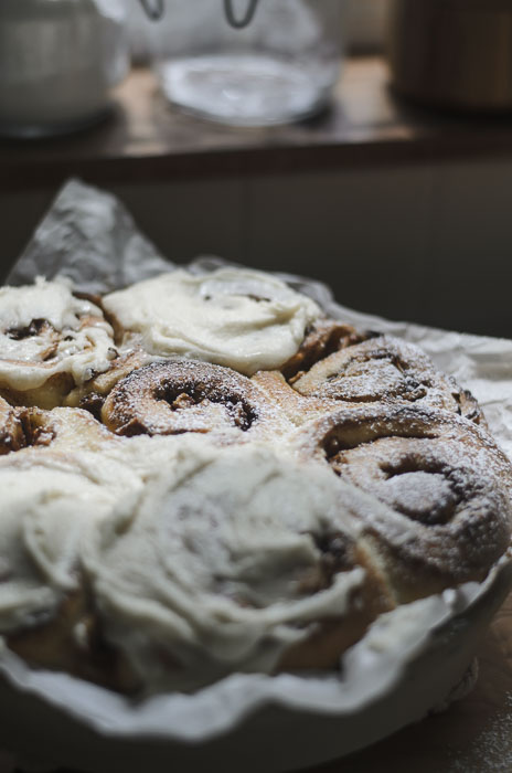 frosted and topped with powdered sugar sourdough apple cinnamon rolls