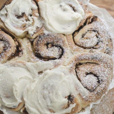 frosted and topped with powdered sugar sourdough apple cinnamon rolls