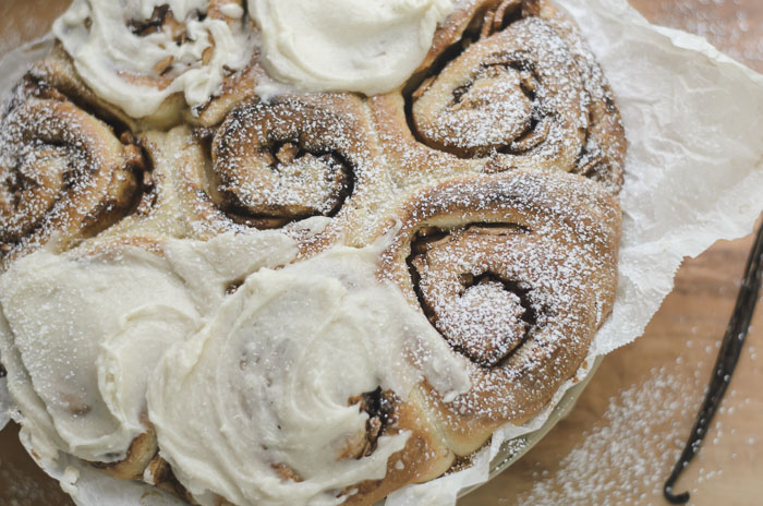 frosted and topped with powdered sugar sourdough apple cinnamon rolls
